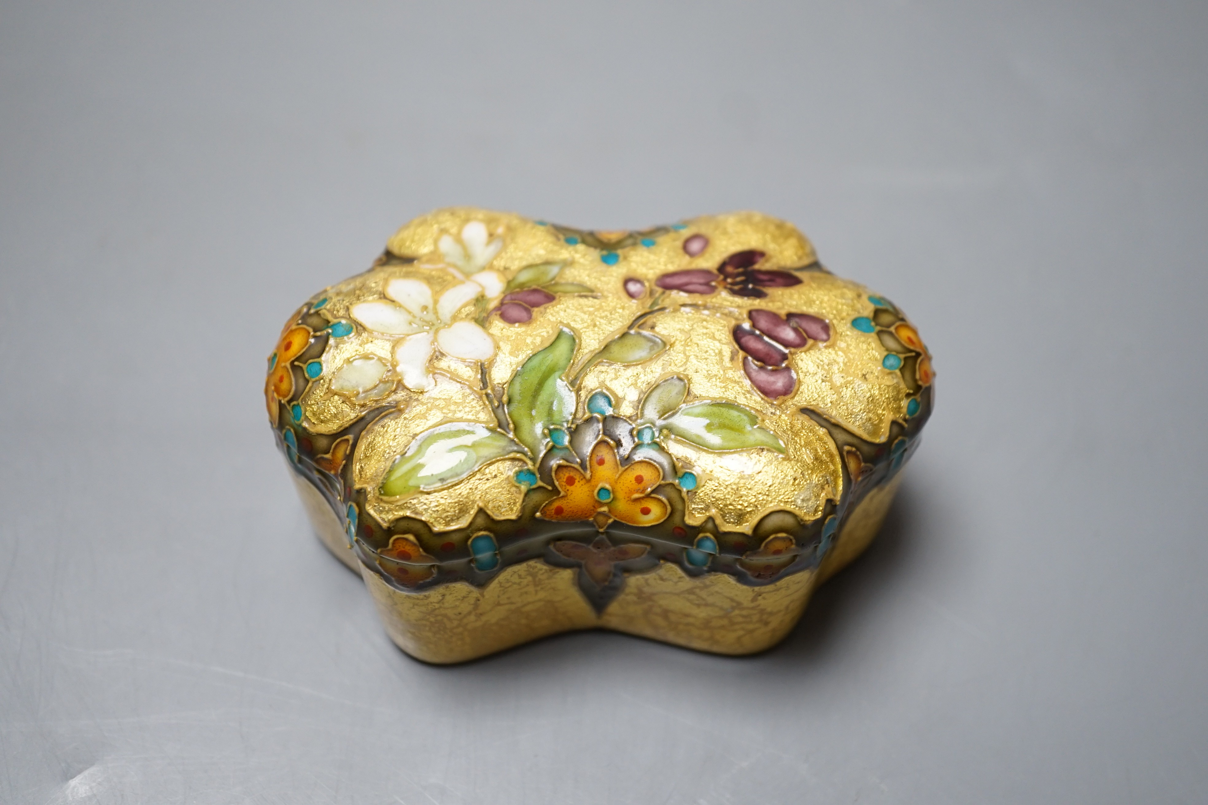 A Clement Massier, Golfe Juan box with enamelled floral decoration on ground yellow base, 9.5cm, original paper labels